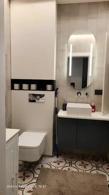 a bathroom with a sink and a toilet and a mirror at HaPPy iNN Brilliant Old Town self check in, Underground Parking, Terrace in Vilnius