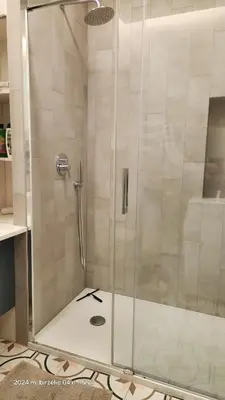 a shower with a glass door in a bathroom at HaPPy iNN Brilliant Old Town self check in, Underground Parking, Terrace in Vilnius
