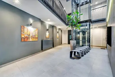 a lobby with a row of chairs and a plant at HaPPy iNN Brilliant Old Town self check in, Underground Parking, Terrace in Vilnius