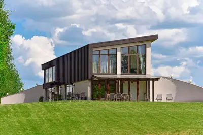a house on top of a hill with grass at Green Harmony in Antalgė