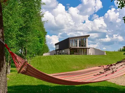 a hammock in front of a house at Green Harmony in Antalgė