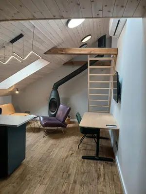 an office with a loft bed and a desk at Loft style studio in the Old Town in Kaunas