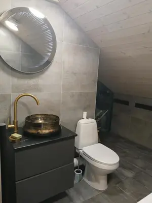 a bathroom with a toilet and a sink and a mirror at Loft style studio in the Old Town in Kaunas