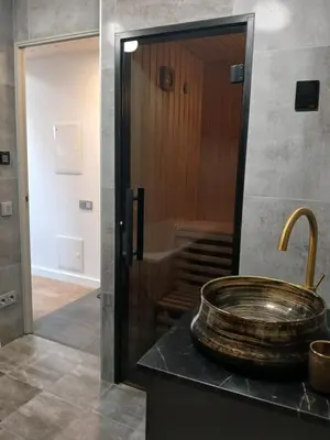 a bathroom with a counter with a sink and a staircase at Loft style studio in the Old Town in Kaunas