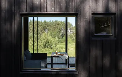 a view of a room with a table and a window at Konga Stay M - Private Jacuzzi Included in Strakiškiai
