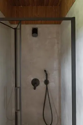 a shower with a shower head on a wall at Konga Stay M - Private Jacuzzi Included in Strakiškiai