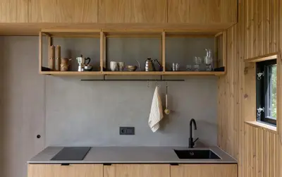 a kitchen with a sink and wooden cabinets at Konga Stay M - Private Jacuzzi Included in Strakiškiai