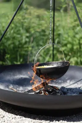 a wok on top of a grill with fire at Konga Stay M - Private Jacuzzi Included in Strakiškiai