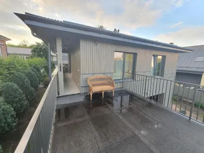 a balcony of a house with a chair on it at Apartment with Terrace in Vilnius