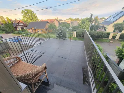 a balcony with a chair and a fence at Apartment with Terrace in Vilnius