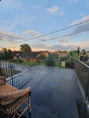 a patio with a chair and a fence at Apartment with Terrace in Vilnius