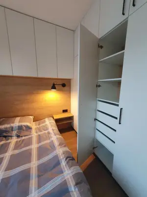 a bedroom with a bed and white cabinets at Apartment with Terrace in Vilnius