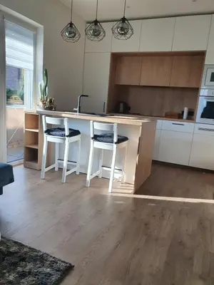 a kitchen with a counter and stools in a kitchen at Apartment with Terrace in Vilnius