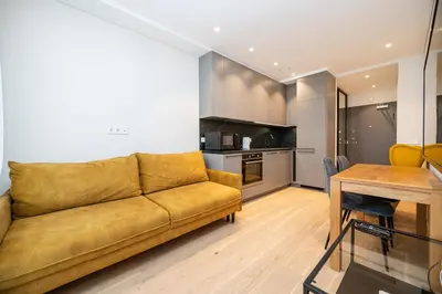 a living room with a couch and a table at Scandinavian style apartment in Vilnius