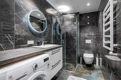 a bathroom with a sink and a toilet and a mirror at Scandinavian style apartment in Vilnius