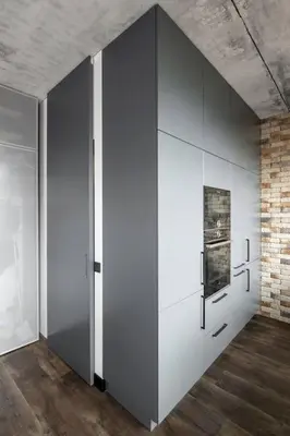 a room with white cabinets and a brick wall at Boutique Studio with Free Parking & AC in Kaunas