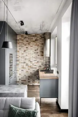a living room with a couch and a kitchen at Boutique Studio with Free Parking & AC in Kaunas