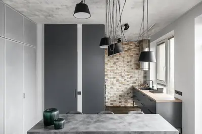 a kitchen with a dining table and a brick wall at Boutique Studio with Free Parking & AC in Kaunas