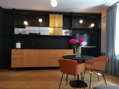 a kitchen with a table with pink flowers on it at Saviciaus in Vilnius