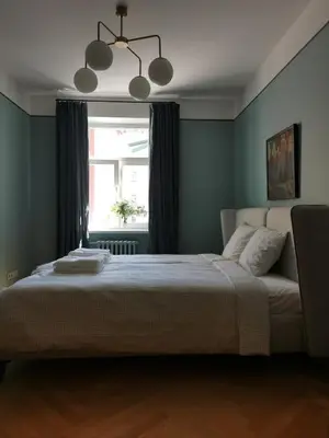 a bedroom with a large bed in front of a window at Saviciaus in Vilnius