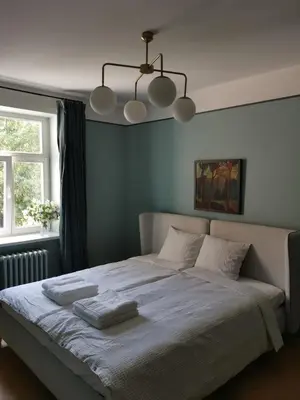 a bedroom with a large bed with two towels on it at Saviciaus in Vilnius