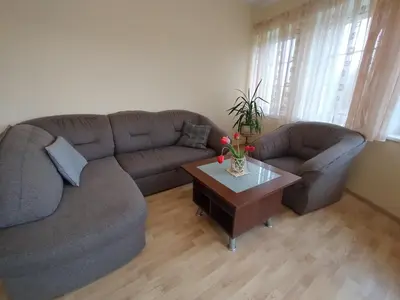 a living room with a couch and a coffee table at A Tranquil Oasis, Lakeview Home in Lapes Kaunas in Lapės