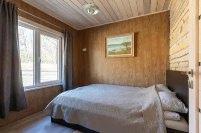 a bedroom with a bed and a window at Bačkis camp in Bačkonys