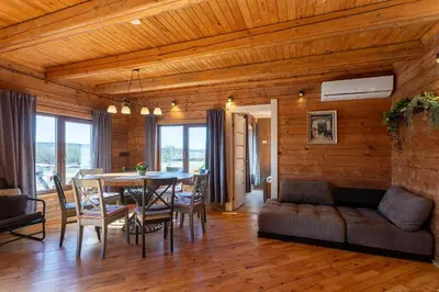 a dining room with a table and a couch at Bačkis camp in Bačkonys