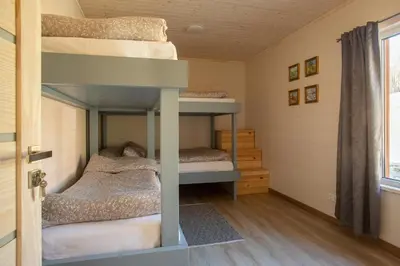 two bunk beds in a small room with a window at Bačkis camp in Bačkonys