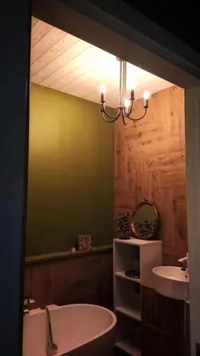a bathroom with a bath tub and a sink at Svečių namelis KNYGŲ NAMAS in Kelmė