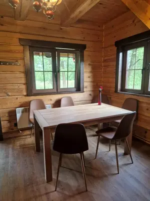 a dining room with a table and chairs at Pirtis su ežero pakrante Trakai in Salkininkai