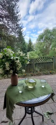 a table with a green table cloth and bowls on it at Žalioji vila in Varteliai