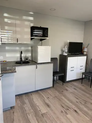 a kitchen with white cabinets and a counter top at A&D Apartament in Kaunas