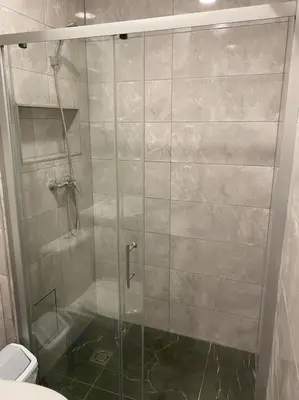 a shower with a glass door in a bathroom at A&D Apartament in Kaunas
