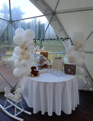 a table with white balloons and teddy bears on it at Pavasario Namai & SPA in Butrimiškiai