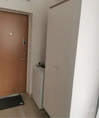 a room with a door and a washer and dryer at Lauros & R apartamentai in Panevėžys