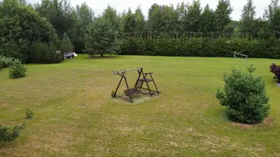 an object in the middle of a grass field at Poilsio Pieva in Ąžuolų Būda