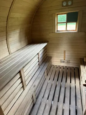 an empty wooden sauna with a window in it at Poilsio Pieva in Ąžuolų Būda