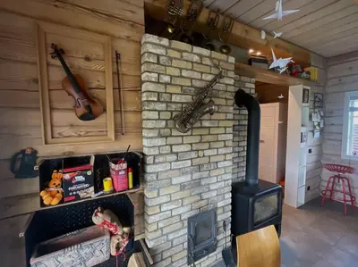 a brick fireplace with a stove in a room at Namelis su pirtimi in Kaunas