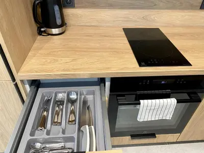 a kitchen with a stove and a counter top at White Lotus Apartment 13 by Reside Baltic in Vilnius