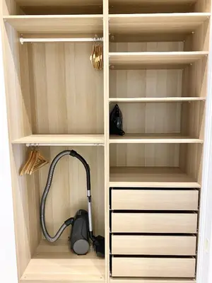 a hutch with a vacuum in a closet at White Lotus Apartment 13 by Reside Baltic in Vilnius