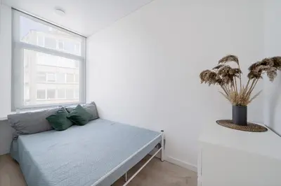 a white room with a couch and a window at Central Cozy 1Bedroom Apartment with Sofa Bed - Sleeps 4 in Vilnius