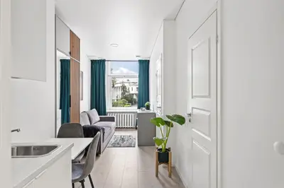 a kitchen and living room with a table and chairs at Central Cozy 1Bedroom Apartment with Sofa Bed - Sleeps 4 in Vilnius