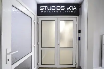 a door to a building with a sign above it at Central Cozy 1Bedroom Apartment with Sofa Bed - Sleeps 4 in Vilnius