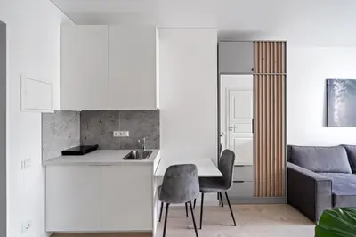 a kitchen and living room with a table and chairs at Central Cozy 1Bedroom Apartment with Sofa Bed - Sleeps 4 in Vilnius