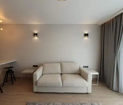 a living room with a white couch and a table at Cozy flat 911 in Vilnius