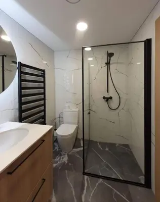 a bathroom with a shower and a sink and a toilet at Cozy flat 911 in Vilnius