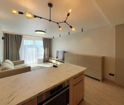 a large kitchen with a large island in a room at Cozy flat 911 in Vilnius