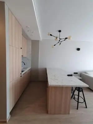 a kitchen with a counter and a table in a room at Cozy flat 911 in Vilnius