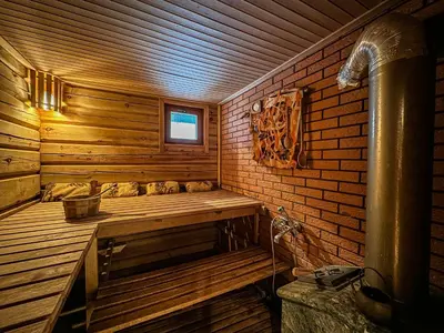 a sauna with a bench in a wooden room at Pirtelė Rykštelė in Karmėlava